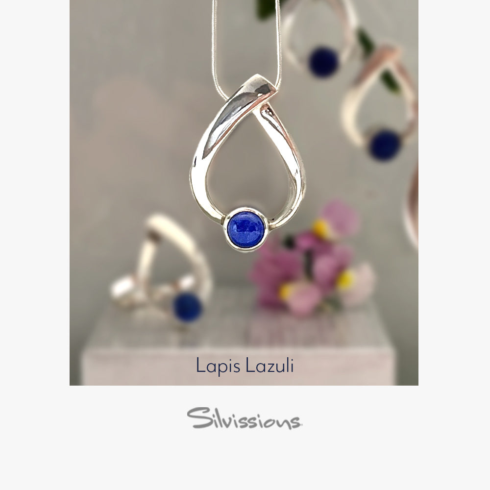Silver pendant with a blue gemstone on a light gray background, branded 'Silvissions'.