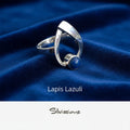 Silver ring with lapis lazuli stone on blue fabric, featuring 'Silvissions' brand.