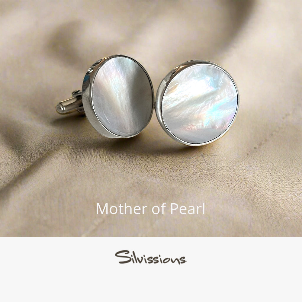 Pair of mother of pearl cufflinks on a beige fabric background with 'Silvissions' branding.