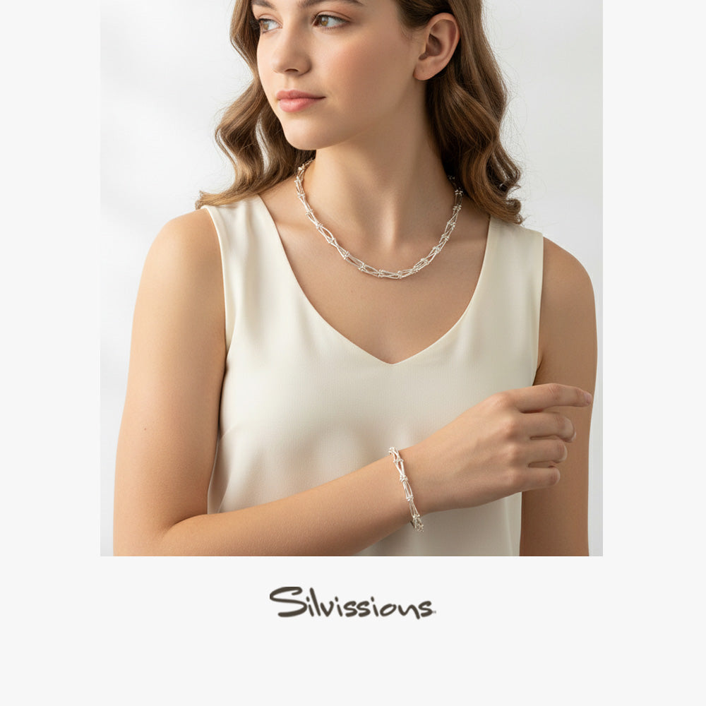 Woman wearing a silver necklace and bracelet with 'Silvions' branding.