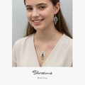 Teen girls wearing silver jewelry with 'Silvissions' branding on a plain background