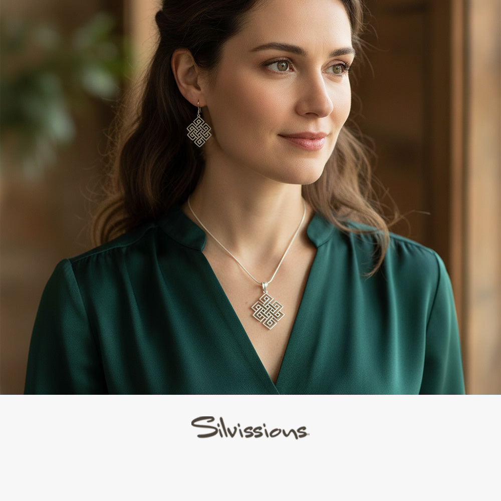 Woman wearing a necklace and earrings with a blurred background, featuring the brand 'Silvissions'.