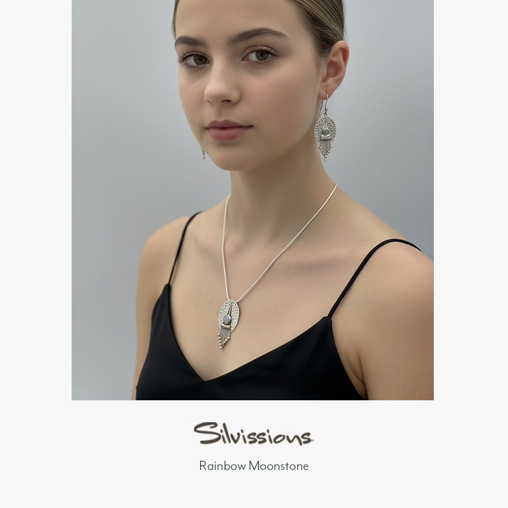 Teen girl wearing a necklace and earrings with 'Silvissions' branding on a gray background