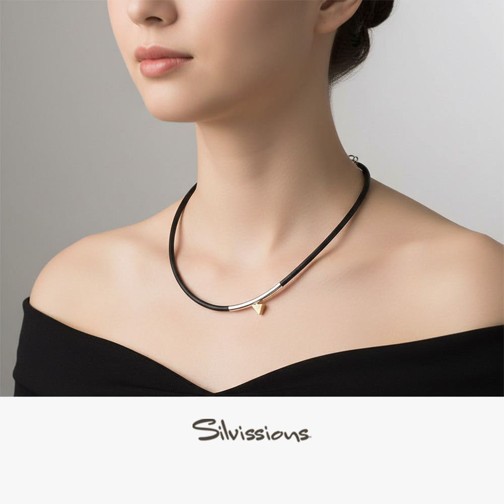 Necklace with a triangle pendant on a person's neck, featuring Silvissions Jewelry branding.
