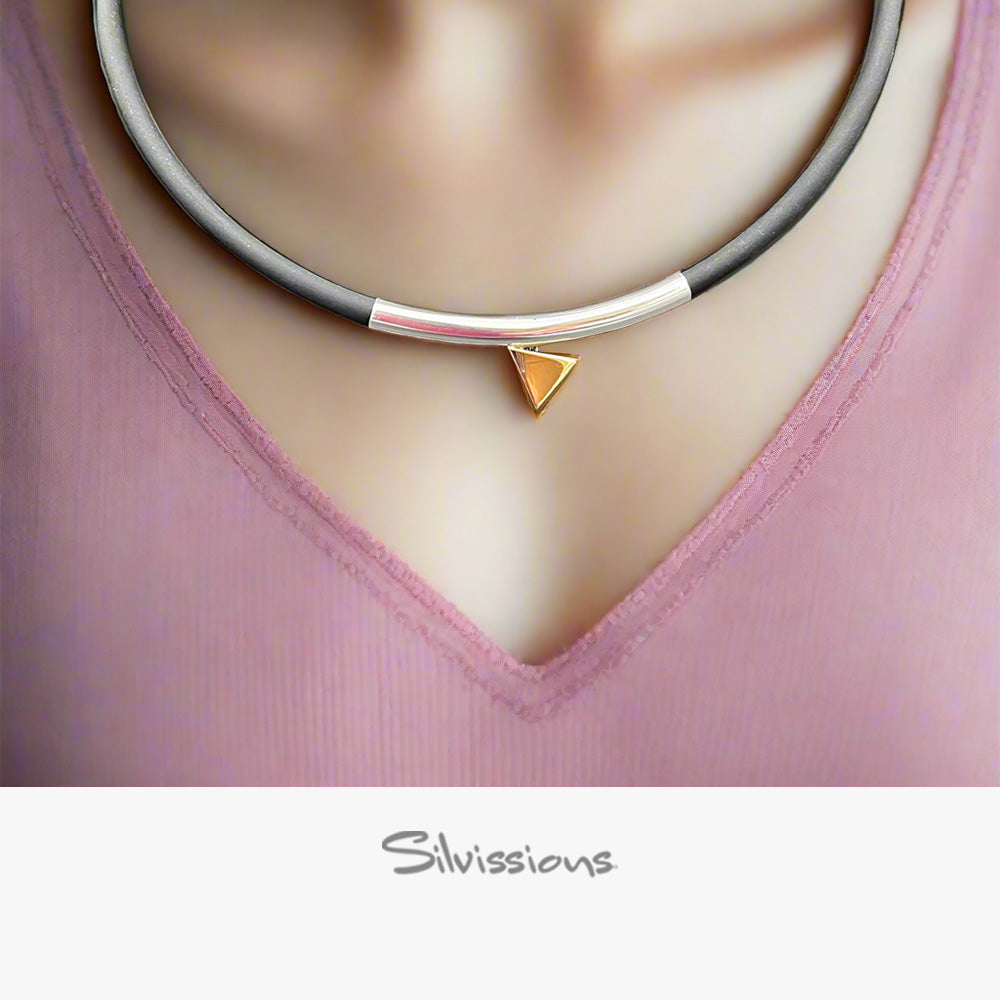 Necklace with a triangle pendant on a person's neck, featuring Silvissions Jewelry branding.