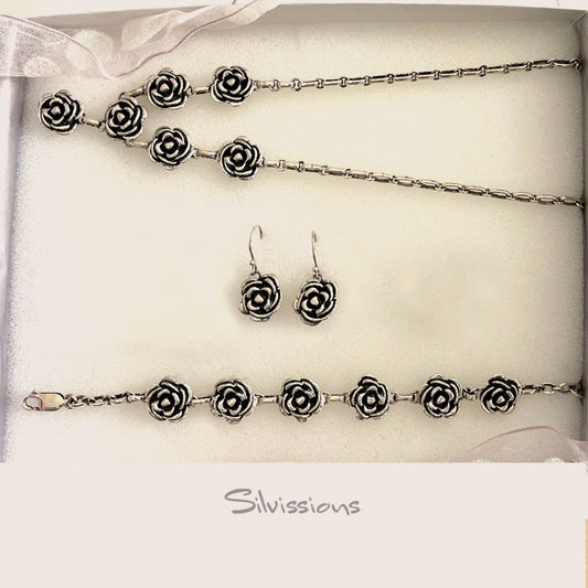 Jewelry set with rose designs including a necklace, bracelet, and earrings on a white background with 'Silvissions' branding.