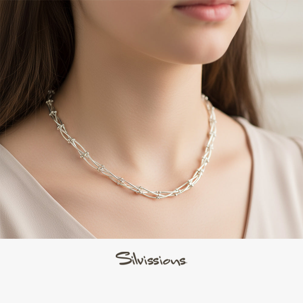 Silver necklace on a blurred background with 'Silvissions' branding.