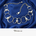Silver necklace with circular links and embedded beads on a beige background, branded 'Silvissions'.