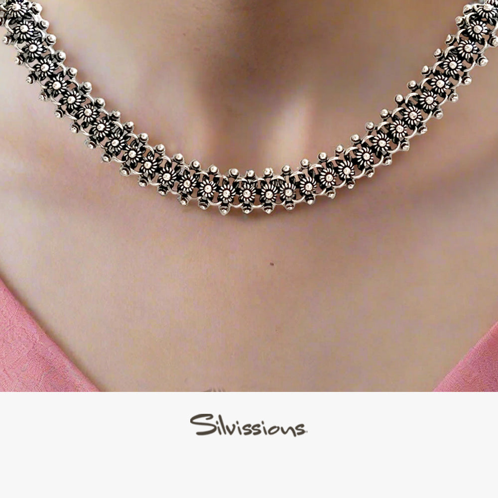 Silver necklace on a person with 'Silvissions Jewelry' branding