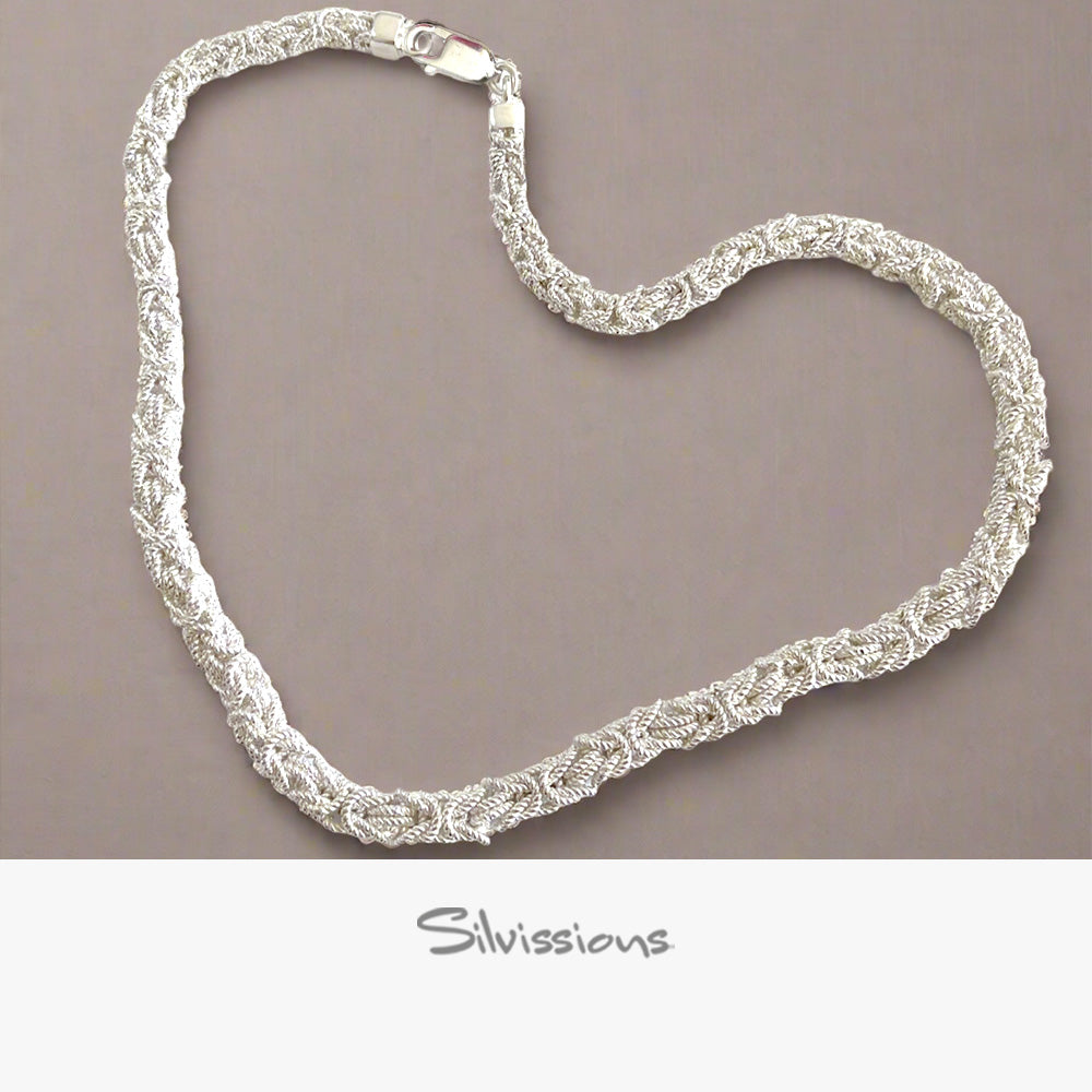 Silver necklace on a brown background with 'Silvissions' branding.