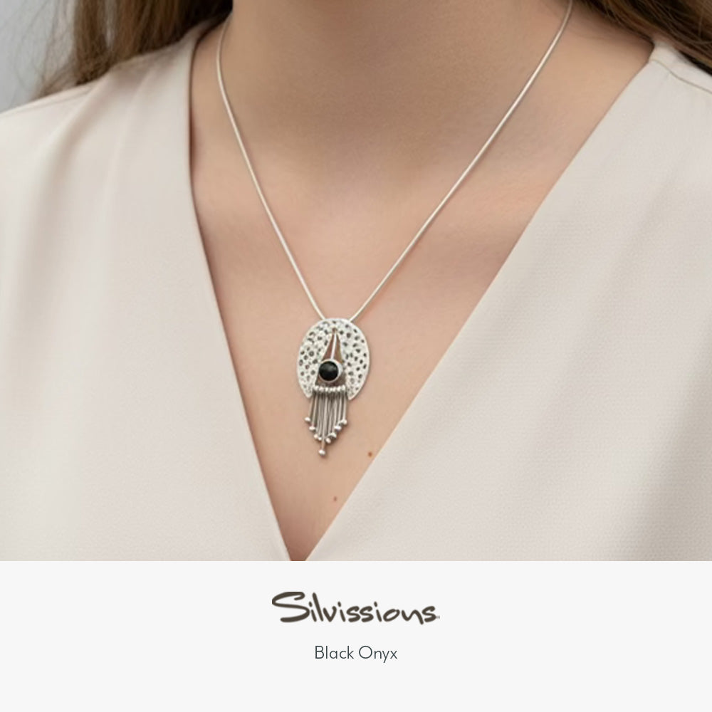 Woman wearing silver jewelry with 'Silvassions' branding on a plain background