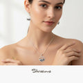 Woman wearing a silver necklace and earrings with 'Silvissions' branding.