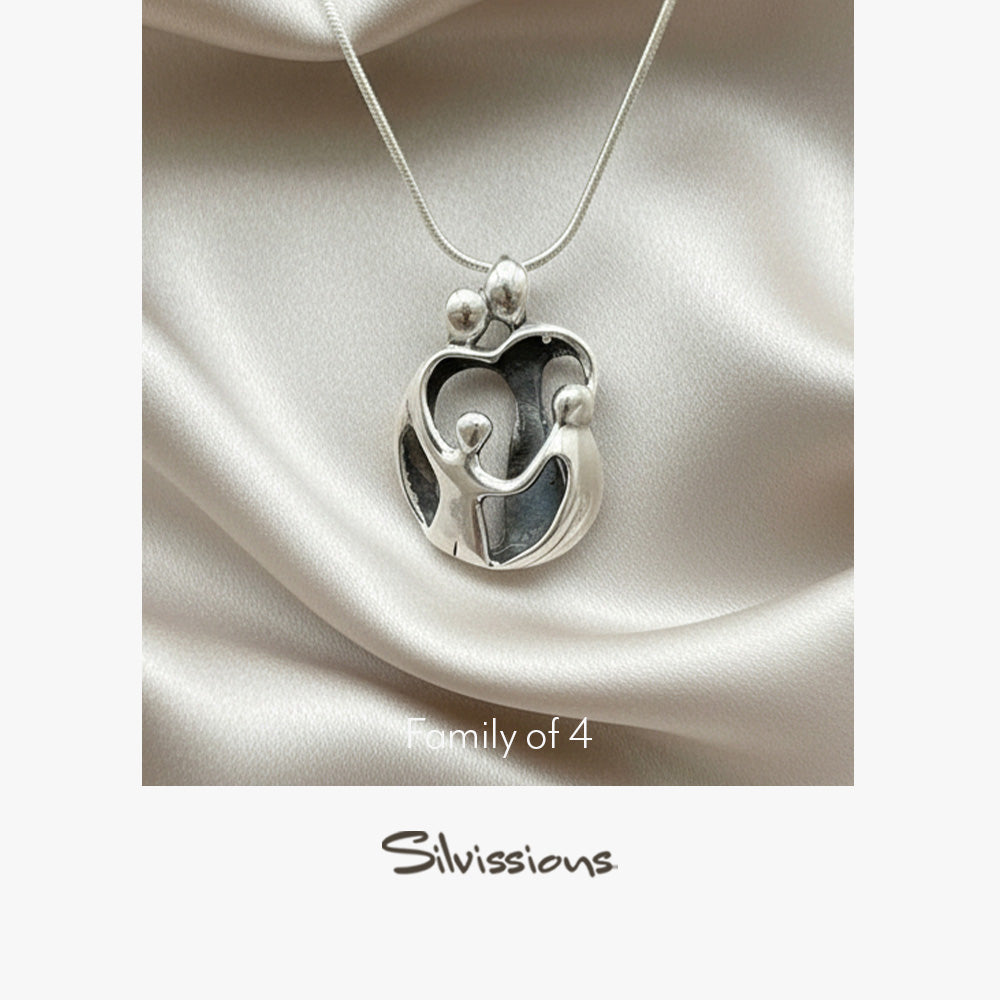 Silver necklace with a family-shaped pendant on a satin surface, featuring the Silvissions brand.