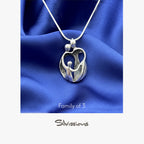 Silver pendant on a blue fabric background with 'Silvissions Jewelry' branding.