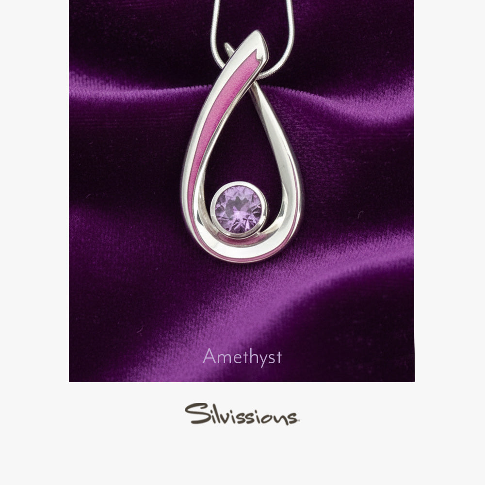 Silver pendant with a purple gemstone on a purple satin background, featuring the brand 'Silvissions'.