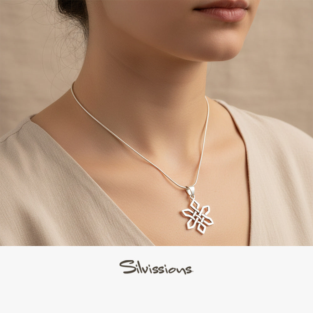 Silver necklace with a pendant worn by a person, brand 'Silvissions' visible