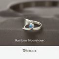 Silver ring with a rainbow moonstone on a neutral background, featuring the brand 'Silvissions'.