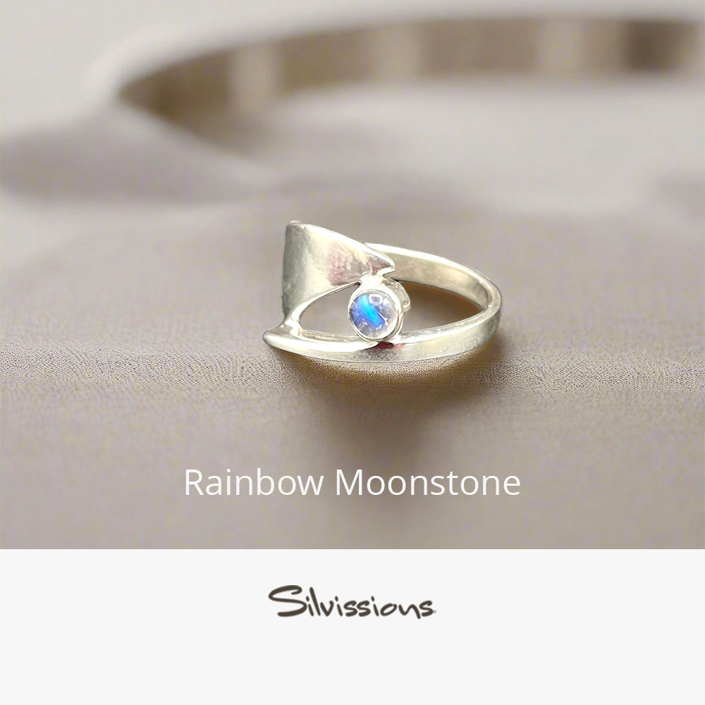 Silver ring with a rainbow moonstone on a neutral background, featuring the brand 'Silvissions'.