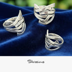 Three silver rings on a blue fabric background with 'Silvissions' branding.