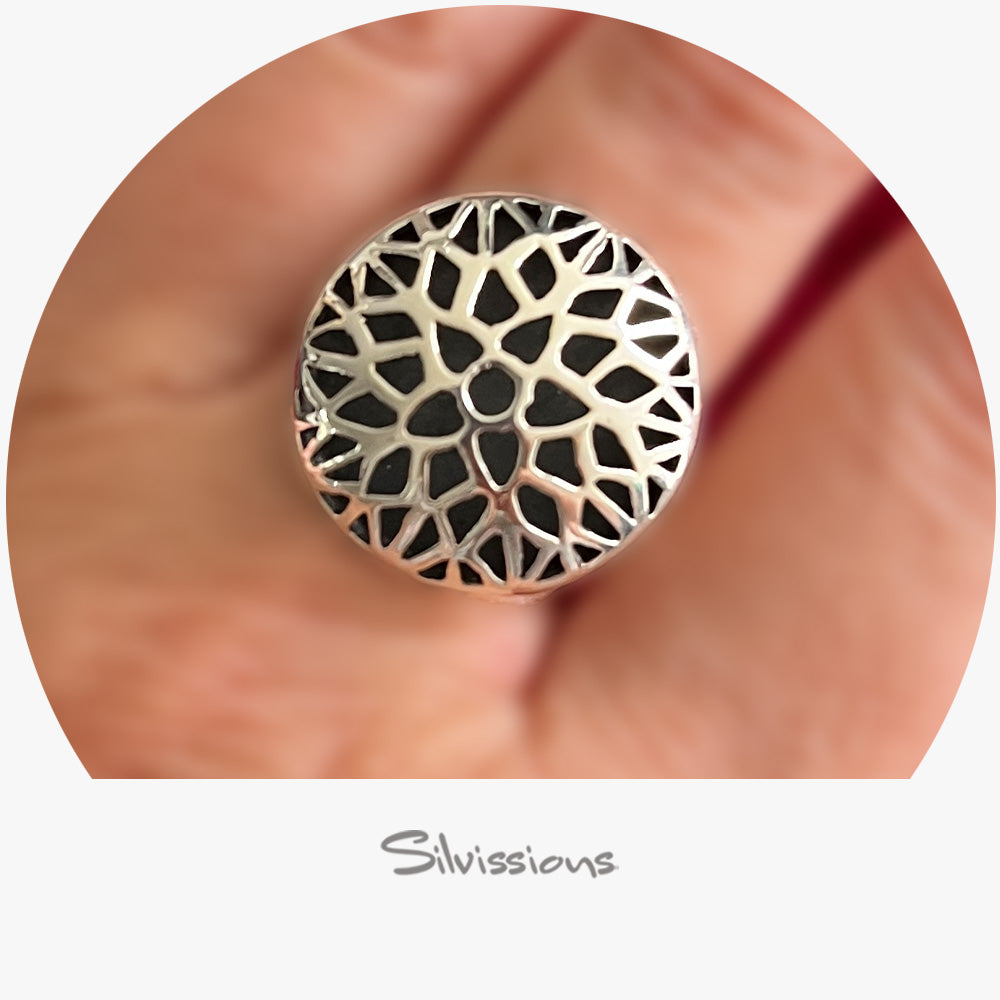 A handcrafted sterling silver ring with a geometric triangular and heart-shaped design, featuring a flat oxidized silver piece on the back.