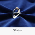 Silver ring on blue fabric with 'Silvissions' branding
