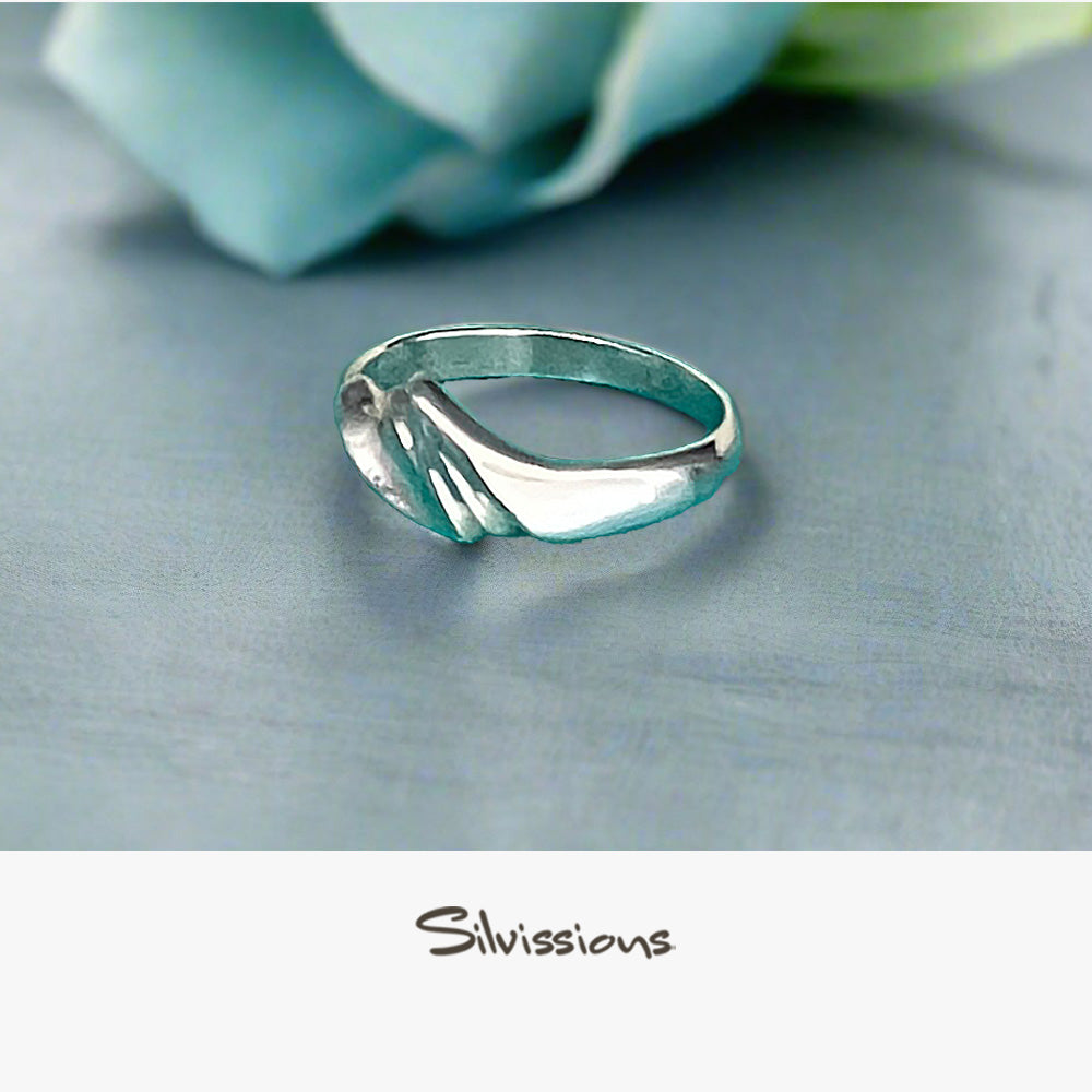 Silver ring on a light blue fabric background with 'Silvissions' branding.
