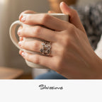 A sterling silver ring with a design that resembles a family unit, featuring a man, woman, and a son and daughter located on a finger.