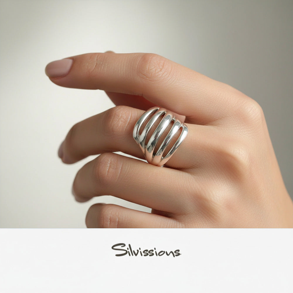 Silver ring on a finger with 'Silvissions' branding