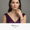 A model wearing a handcrafted sterling silver and amethyst gemstone jewellery set, including earrings, ring, bracelet, and pendant.