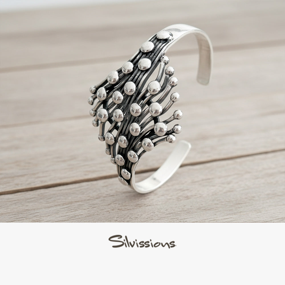 Silver bracelet with a unique design on a light gray background, featuring the brand 'Silvissions'.