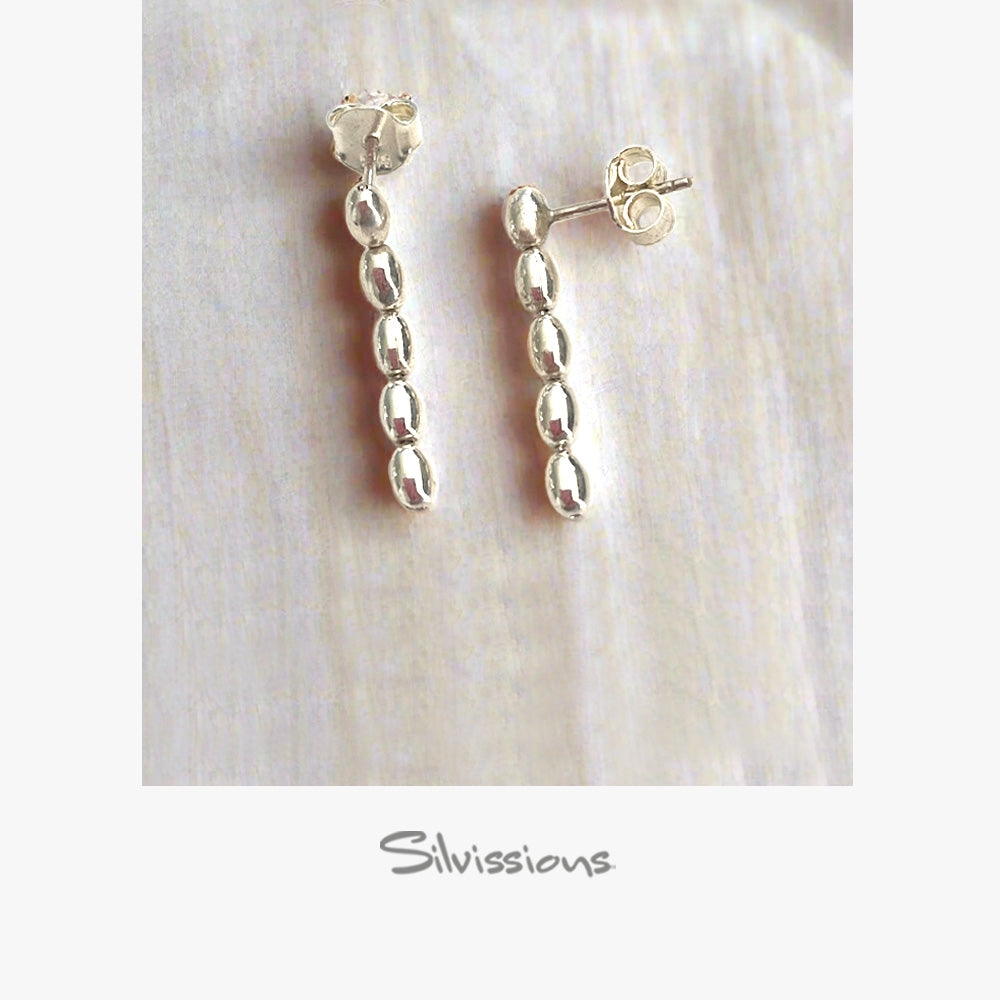 Silver beaded earrings on a light background with 'Silvissions' branding.