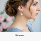 A pair of sterling silver stud earrings featuring a rainbow moonstone gemstone set above a faux pearl, displayed against a pink background with the text 'Rainbow Moonstone' and 'Silvissions'.