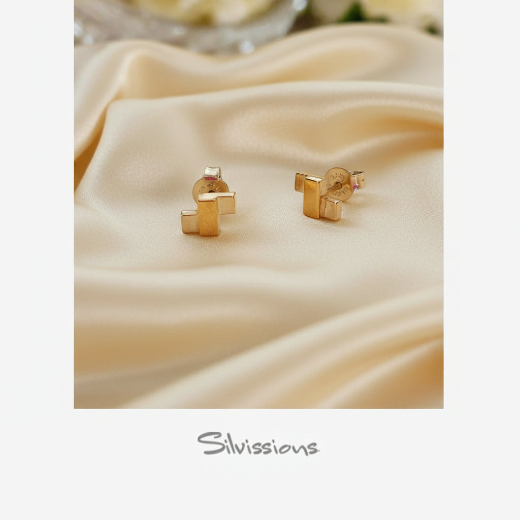 Sterling Silver and mixed metal stud earrings on a white fabric with 'Silvissions' branding.