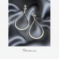 Silver teardrop earrings on a light gray background with 'Silvissions' branding.