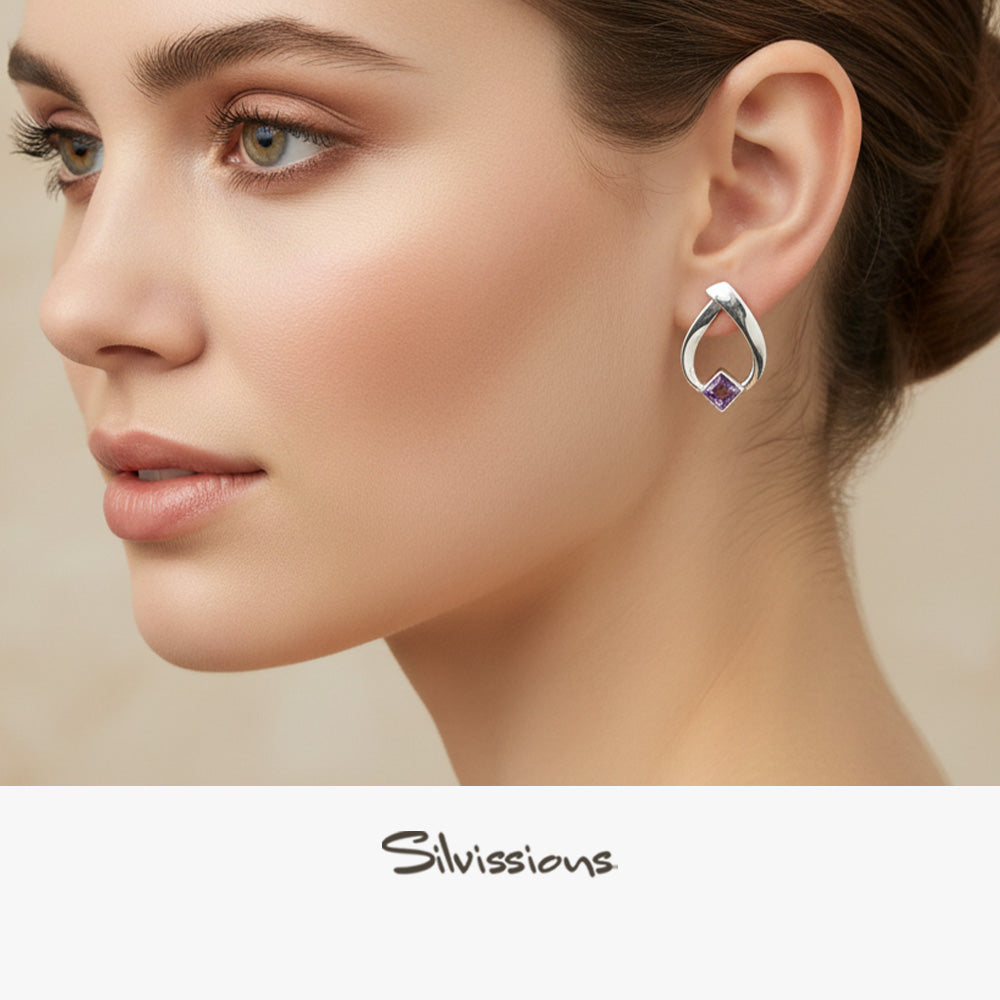 Close-up of a woman wearing a silver stud earring with a purple gemstone, branded 'Silvissions'.