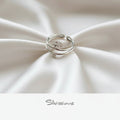 Silver toe ring on a beige plate with 'Silvissions' branding.