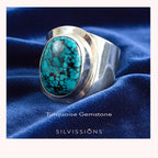 Silver ring with turquoise gemstone on blue fabric, featuring 'Silvissions' branding.