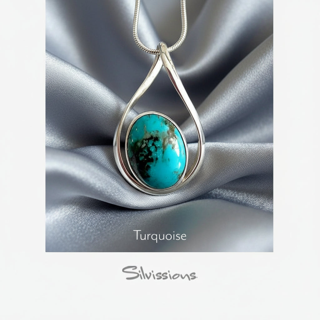 Turquoise pendant necklace on silver fabric with 'Silvissions' branding