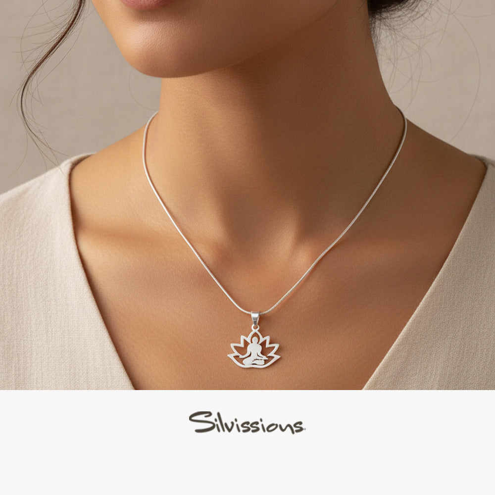 Silver pendant necklace with a yoga design worn by a person, brand 'Silvissions' visible.