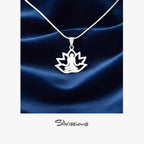 Silver lotus pendant necklace on a blue satin background with 'Silvissions' branding.
